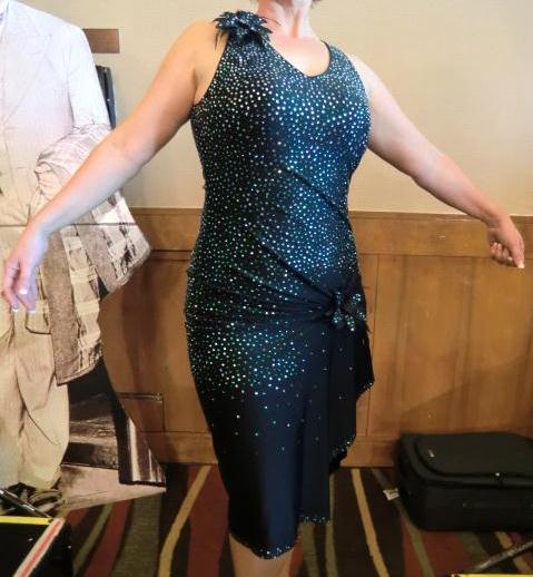 This black rhythm gown is very heavily stoned with crystal and emerald stone